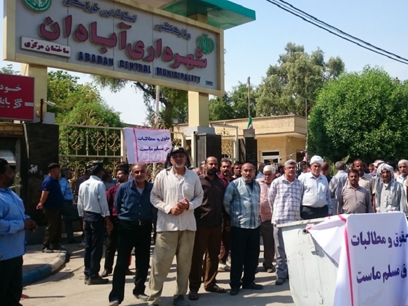 Unpaid municipality workers in Abadan, Iran, block entrance of the municipality building
